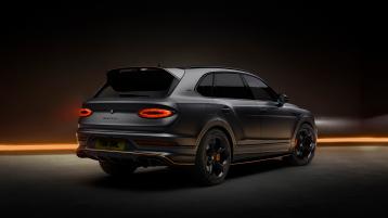 Bentley Bentayga S Black Edition rear 3/4 featuring 22 inch S directional wheel - Black Painted and Polished as well as Mandarin accents on the styling kit