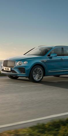 Bentley Bentayga EWB Azure front side angled view in Oceanica colour, featuring Chrome vertical fluted front vanes.