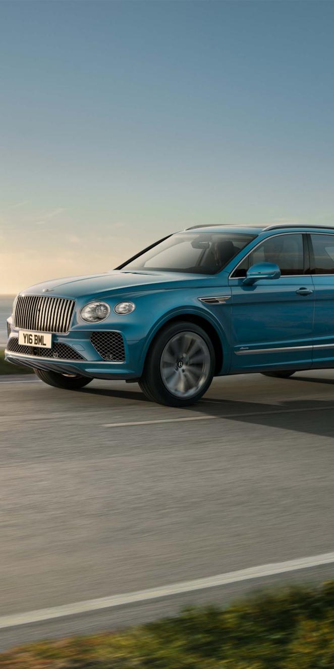 Bentley Bentayga EWB Azure front side angled view in Oceanica colour, featuring Chrome vertical fluted front vanes.