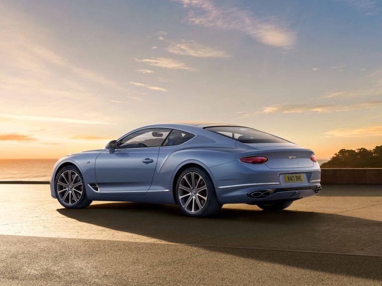 Rear side angled view of Bentley Continental GT A in Silverlake colour featuring 21" Ten Spoke Wheel - Grey Painted and Bright Machined and Bentley wing badge to boot.