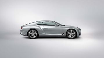 "Side profile of Bentley Continental GT in Moonbeam featuring 21"" Five Tri-Spoke Wheel - Grey Painted and Bright Machined and Bright wing vent with black ribbed matri "