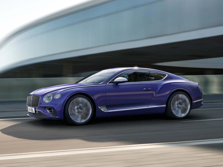 Bentley Continental GT Mulliner in Tanzanite Purple colour featuring 22 inch Mulliner Wheel Painted and Polished driving on a highway.