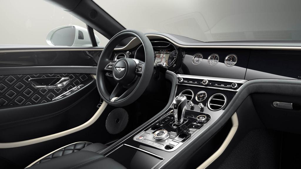 Passenger side view of Bentley Continental GT Speed Edition 12 overlooking driver side with Beluga hide and Grand black veneer with centre console in view.