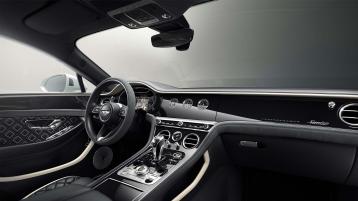 Passenger side interior view of Bentley Continental GT Speed Edition 12 in Grand Black veneer with central console is view.  