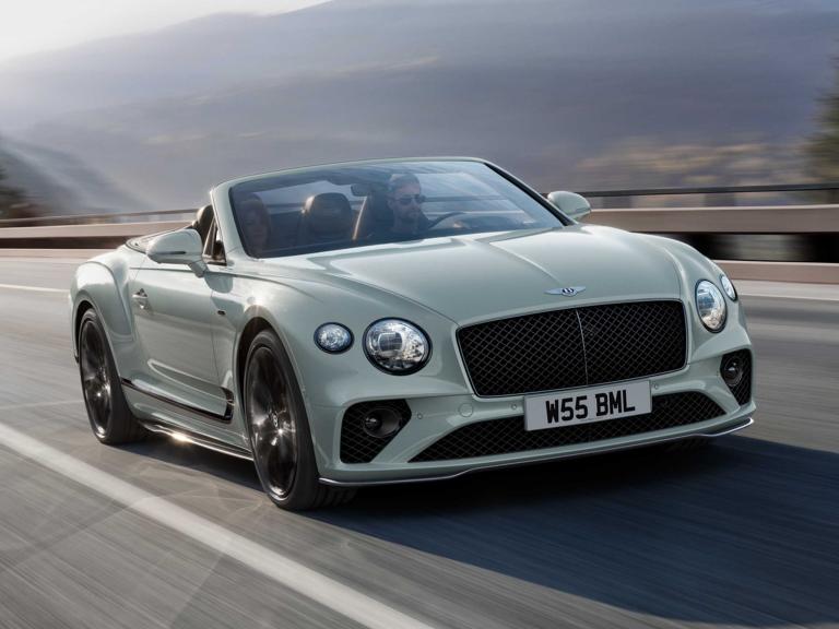 Front view of Bentley Continental GTC Speed Edition 12 in Glacier White colour featuring Matt black matrix grille driving along highway.