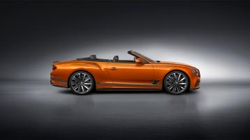 Side view of Bentley Continental GTC Speed in Orange Flame with roof down featuring 22 inch Speed Wheel and Speed fender Badge. 