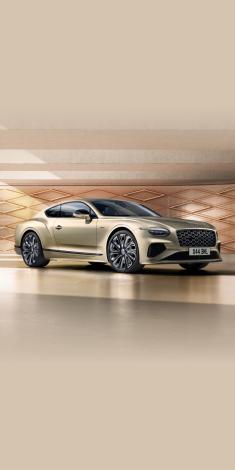 Front side angled view of Bentley Continental GT Mulliner Patina exterior colour, featuring 22 inch Mulliner Wheel Painted and Mulliner double diamond radiator grille - Black.