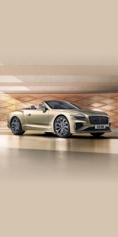 Front side angled view of Bentley Continental GTC Mulliner in Patinafeaturing 22 inch Mulliner Wheel Painted and Mulliner double diamond radiator grille