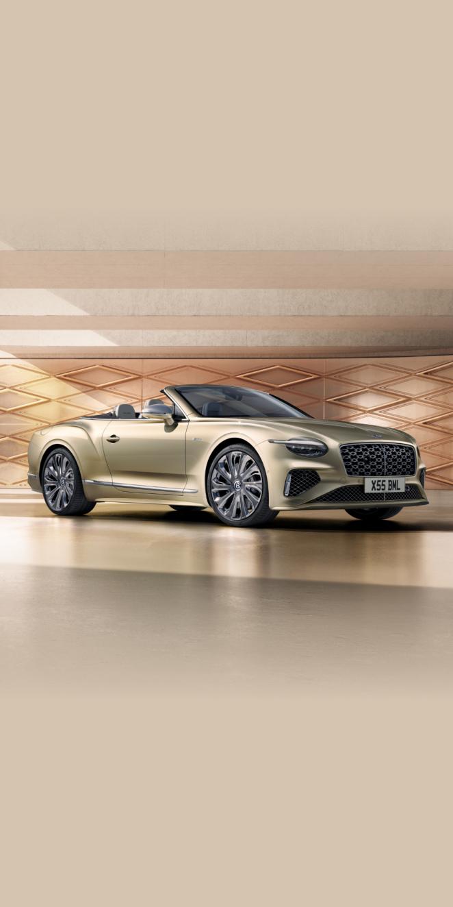 Front side angled view of Bentley Continental GTC Mulliner in Patinafeaturing 22 inch Mulliner Wheel Painted and Mulliner double diamond radiator grille