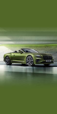 Front side angled view of Bentley Continental GTC Speed in Tourmaline Green exterior colour, featuring 22 inch Speed Wheel - Dark Tint and Black gloss radiator matrix grille with black surround.