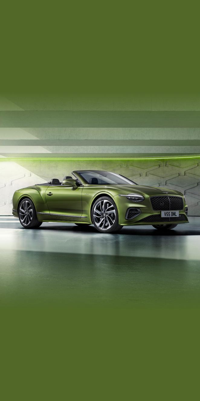 Front side angled view of Bentley Continental GTC Speed in Tourmaline Green exterior colour, featuring 22 inch Speed Wheel - Dark Tint and Black gloss radiator matrix grille with black surround.