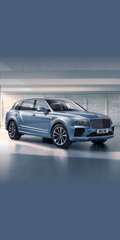 Bentley Bentayga EWB A - V8 in Silverlake colour, side angled view featuring 21 inch Five Twin-Spoke Wheels and fluted chrome grille.