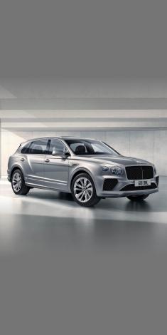 Bentayga EWB in Hallmark side angled view featuring 20 inch wheels and chrome accent side skirt