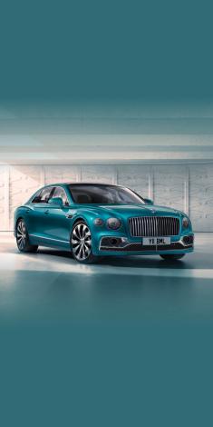 Front side angled view of Bentley Flying Spur Azure V8 in Topaz Blue colour, featuring 22 inch Ten Spoke Wheel - Black Painted and radiator mascot – bright