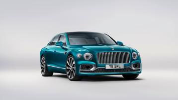 Front side angled view of Bentley Flying Spur Azure V8 in Topaz Blue colour, featuring 22 inch Ten Spoke Wheel - Black Painted and radiator mascot – bright polished steel