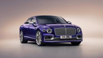 Front side angled view of Bentley Flying Spur Mulliner in Tanzanite Purple colour featuring Black gloss matrix grille with chrome surround