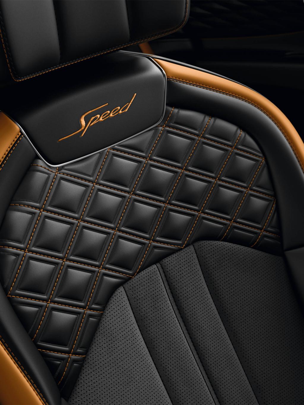 Bentley Flying Spur Speed's seats with detailed contrast stitching and Speed Emblems in Beluga Hide complemented by Mandarin by Mulliner hide,