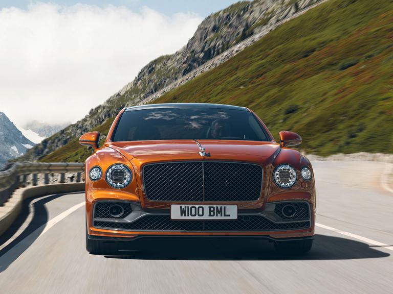 "Bentley Flying Spur in Orange Flame by Mulliner colour featuring  Flying ‘B’ radiator mascot – bright  polished stainless and Matt black matrix grille."