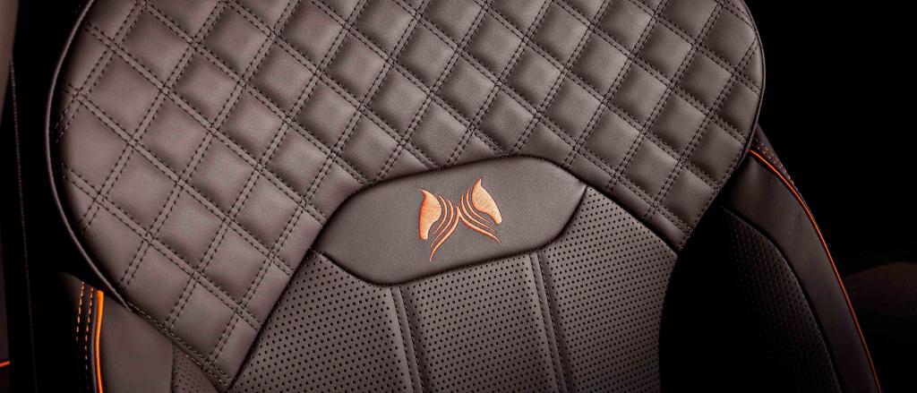 Bentley Bentayga Bentayga S's front seat in focus, featuring detailed Diamond quilt detailed stitching and Orange flame piping witch custom emblem.