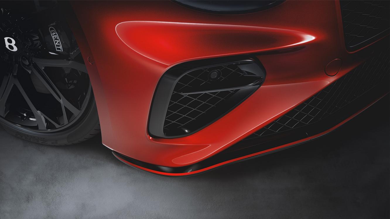 Close up of the front lower bumper of the Bespoke Series 2027 Bentley Continental GT S in Bright Red Pearlescent.