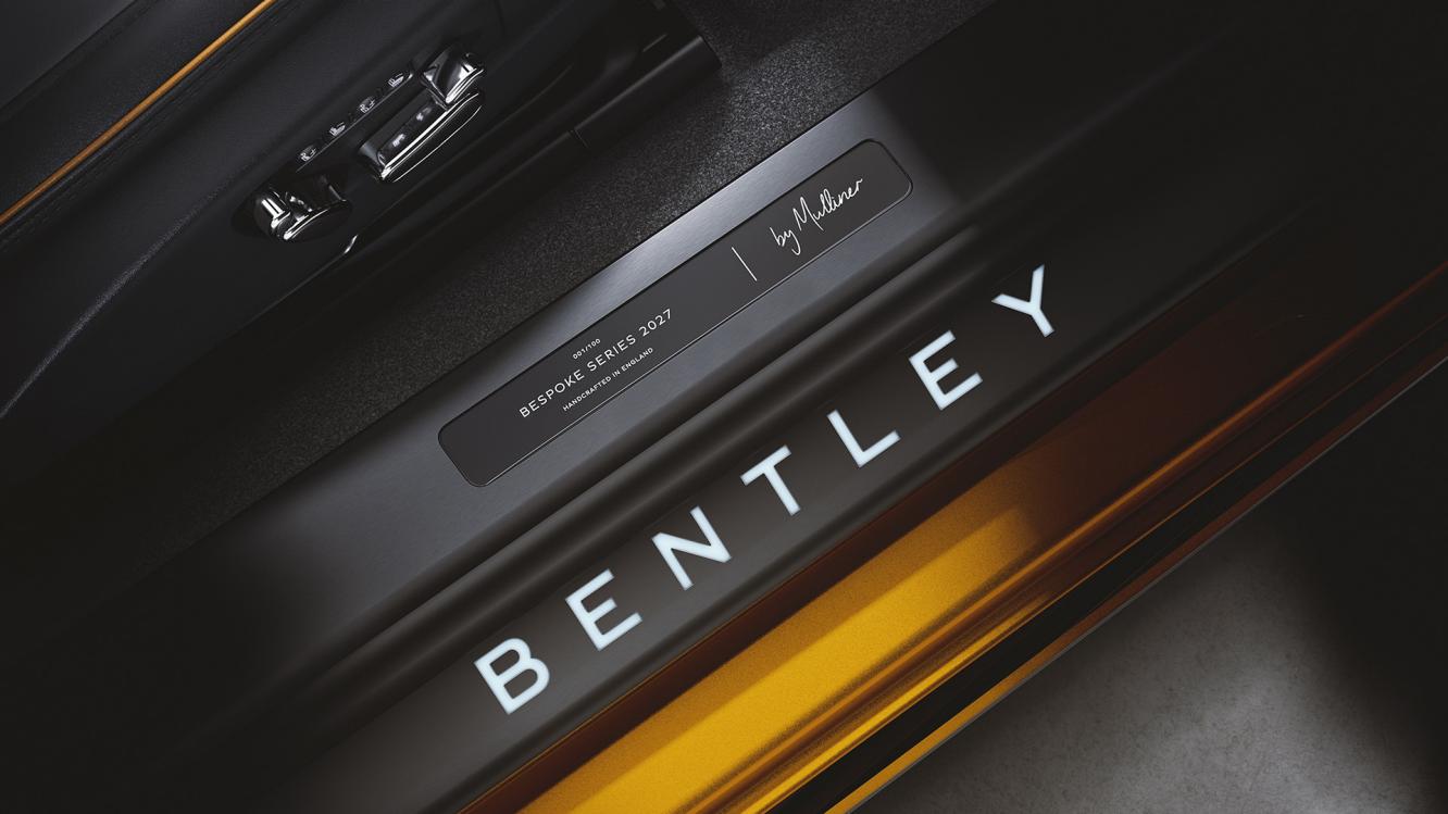 Close up of the individually numbered treadplate on the Bespoke Series 2027 Bentley Continental GT S in Manuka Orange.