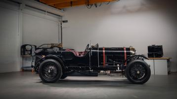 Side view of black coloured Bentley Mulliner Blower parked indoors