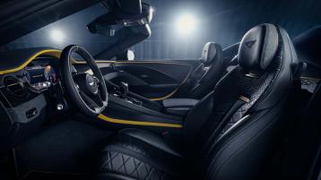 Interior view of Bentley Bacalar featuring Beluga hide - contrasted by Chrome Yellow hide over looking passenger side with tri spoke, indented steering wheel in view.