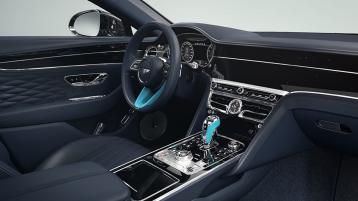 Interior view of Bentley Flying Spur Mulliner in left hand side steering configuration, featuring Grand Black veneer with bespoke Mulliner colours