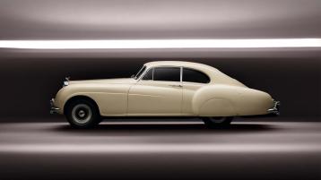  Side view of sleek aerodynamic 1952 R-Type Bentley Continental with alumunium wings and chrome radiator grill 