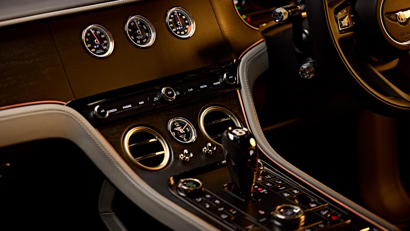 Centre console of Virtuoso Bentley with side of steering wheel in view.