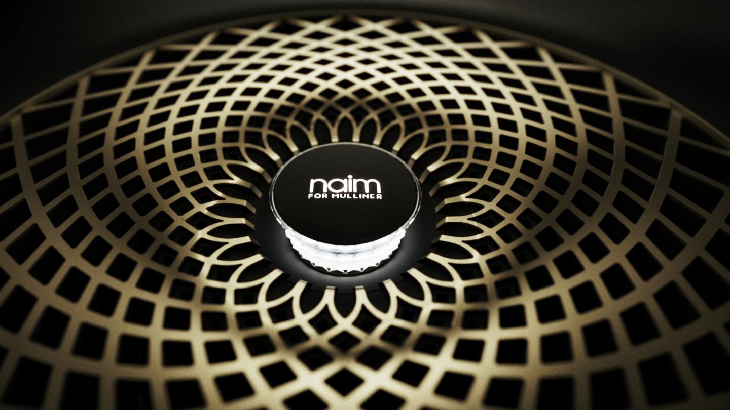 A close up of the new Naim by Mulliner speaker grille in a bespoke gold finish by Mulliner