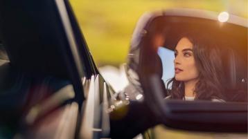 Close up view of side mirrors with lady/person in view.