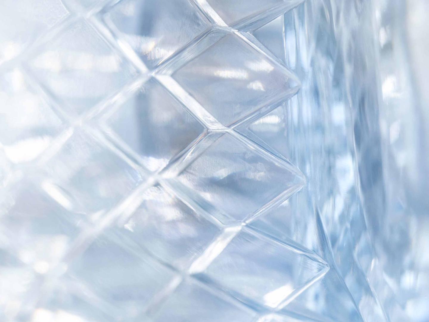 Zoomed in view of Bentley Bentayga EWB Azure head lamp featuring diamond cut patterns.