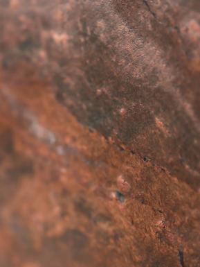 Textured view of red rock stone.