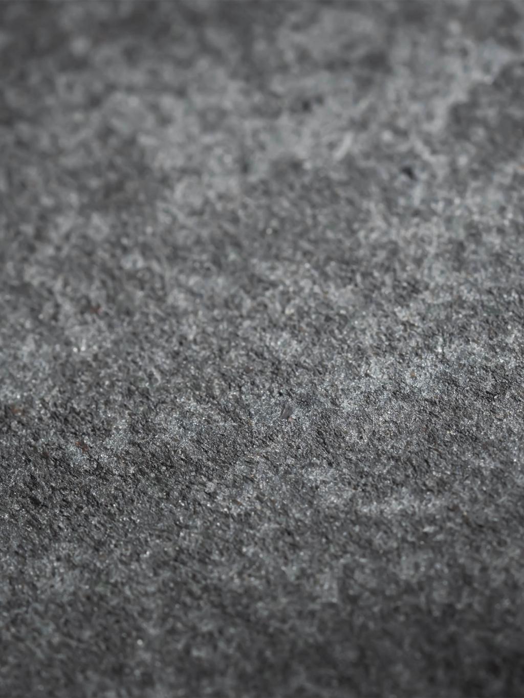 Grey textured view of stone.