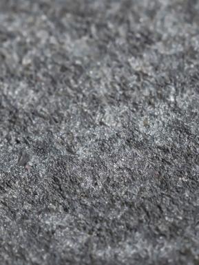 Detailed textured view of grey stone.