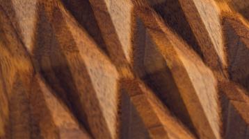 Intricate diamond shaped pattern carved in wood.