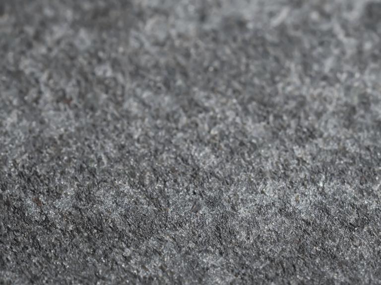 Close up view of grey textured stone.
