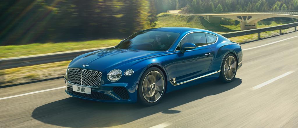 Bentley technician tightening front right wheel nuts of Bentley Continental GT Azure in Kingfisher By Mulliner colour 