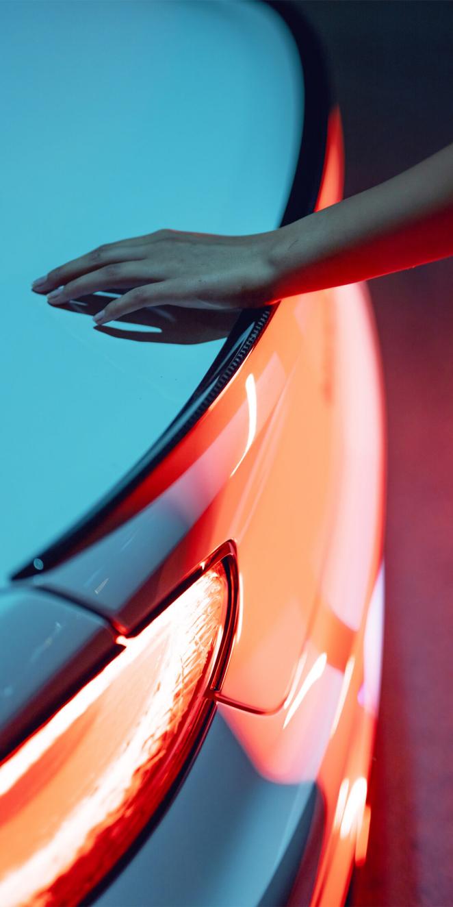 A person with hand placed on Bentley Continental GT's boot.