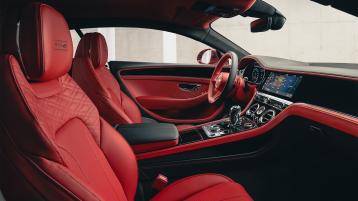 Passenger side view of Bentley Continental GT Speed Edition 12 overlooking driver side with Beluga hide and Grand black veneer with centre console in view.