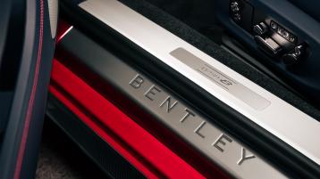 Passenger side interior view of Bentley Continental GT Speed Edition 12 in Grand Black veneer with central console is view.  