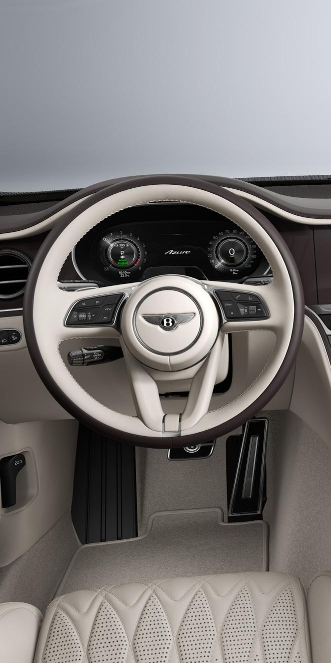 Driver’s view of the Bentley Flying Spur Azure steering wheel with Linen and Burnt Oak interior trim.