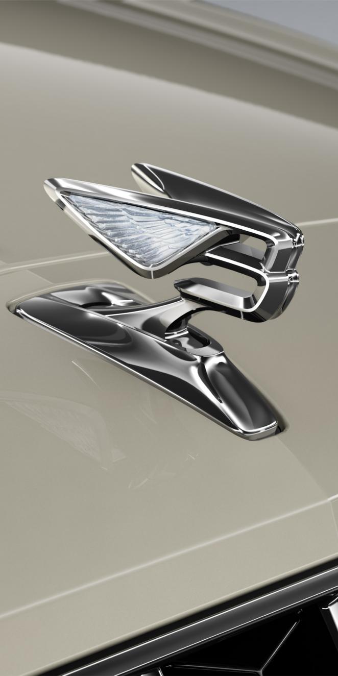 Close-up of the Flying B bonnet mascot on the Bentley Flying Spur Azure in White Sand.