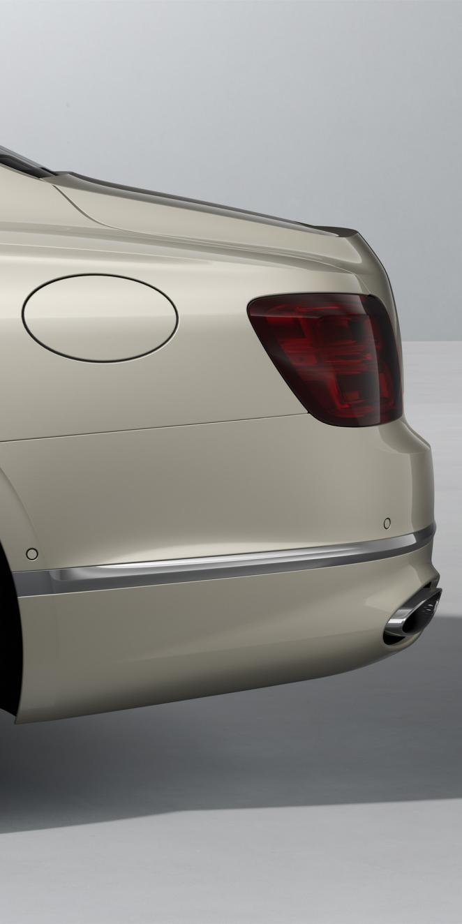 Side view of the rear of the Bentley Flying Spur Azure in White Sand with Bright Chrome Exterior detailing.