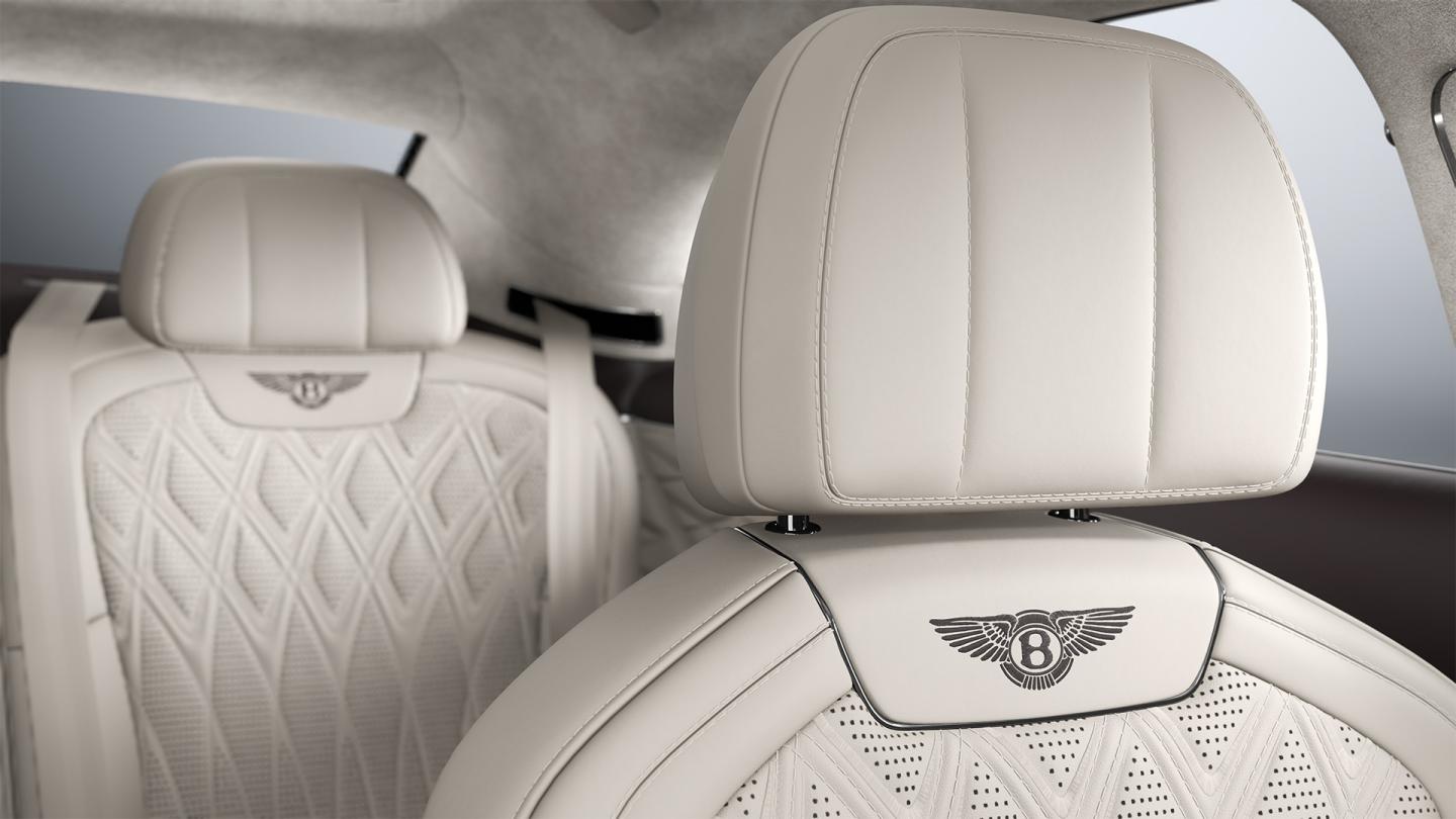 Interior view of the Bentley Flying Spur Azure driver’s seat in Linen and Burnt Oak.