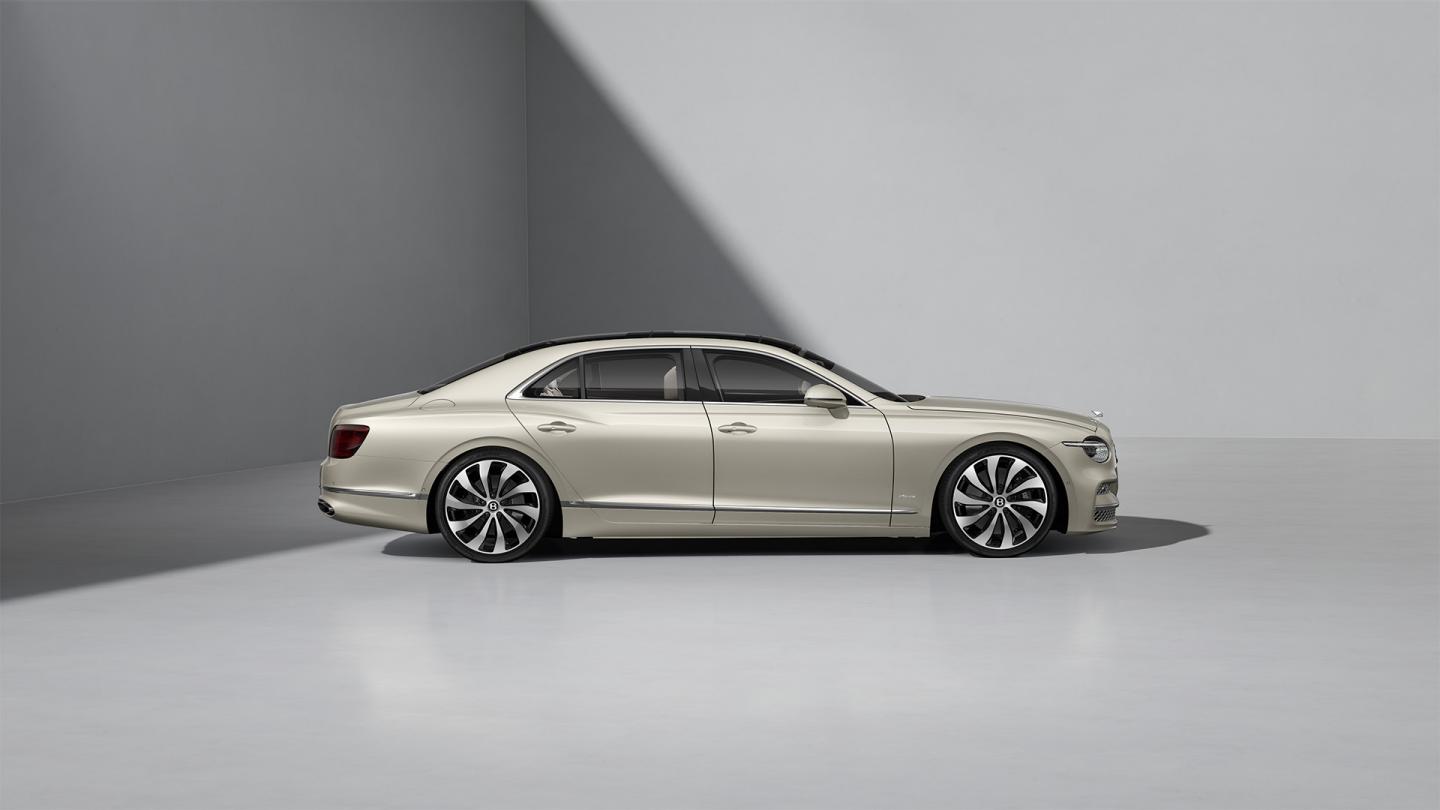 Side profile shot of the Bentley Flying Spur Azure in White Sand with Bright Chrome Exterior detailing.