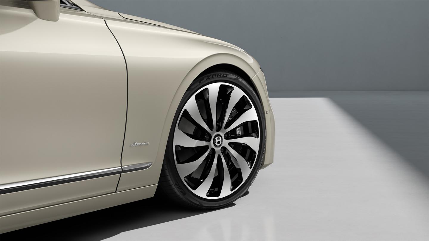 Close-up of the Bentley Flying Spur Azure 22" Ten Spoke Wheel painted in black and bright machined.