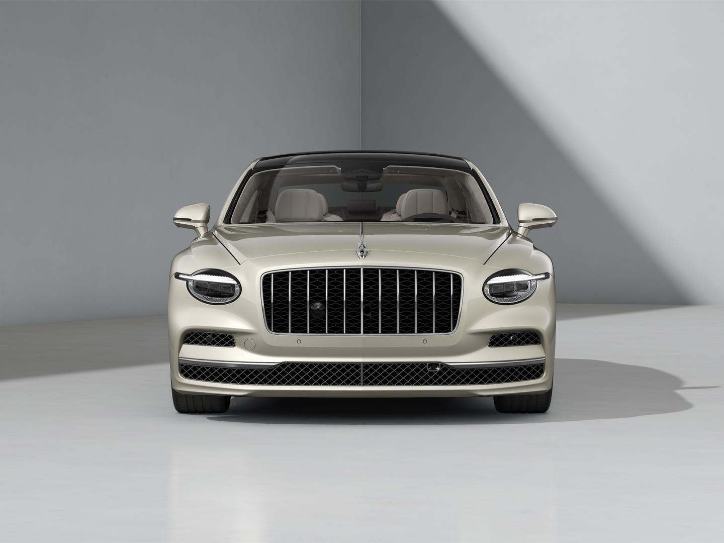 Front-on shot of the Bentley Flying Spur Azure in White Sand with Bright Chrome Exterior detailing.