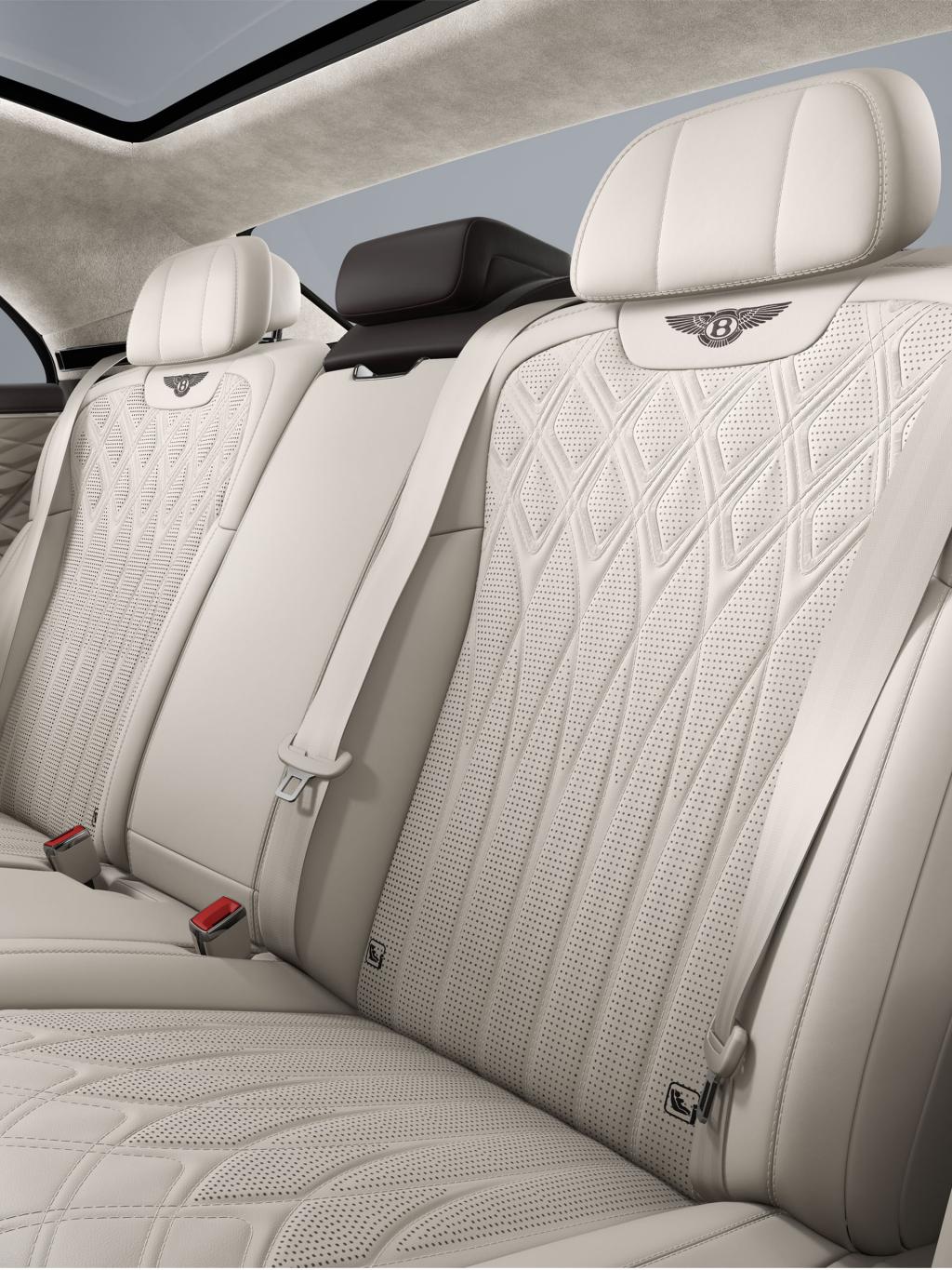 Rear passenger seat view inside the Bentley Flying Spur Azure with Linen and Burnt Oak upholstery and 4+1 seat configuration.
